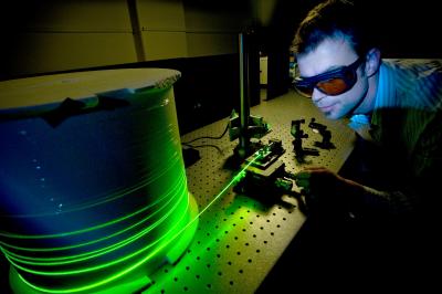 A researcher is testing an optical fiber system in the Institute for Photonics & Advanced Sensing, University of Adelaide. Credit: Photo by Jennie Groom.