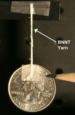 A yarn spun of boron-nitride nanotubes suspends a quarter.