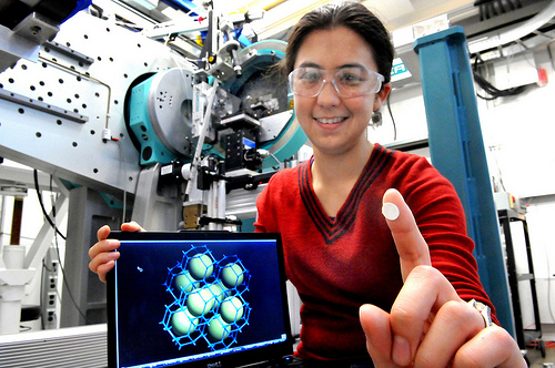 Argonne scientist Karena Chapman holds up a wafer of metal organic framework ZIF-8 with its structure displayed on the computer screen. Chapman along with scientists Peter Chupas and Gregory Halder were able to change the structure of a metal organic framework at pressures low enough for large scale industrial applications.