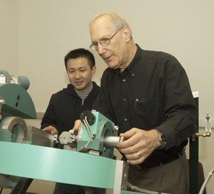 Stuart Solin, Ph.D. (right), discusses graduate student Jian Wus research with a novel crystalline material. They stand behind a six-circle diffractometer, an instrument that uses high-intensity X-rays to determine the position of atoms in crystals. Solin is imaginative, hes clever, and he has an amazing breadth of knowledge in solid-state physics, says Kenneth F. Kelton, Ph.D., chair of physics in Arts & Sciences.