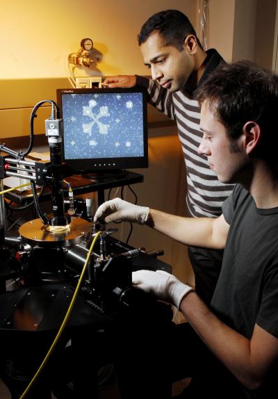 Researchers Raghunath Murali and graduate student Kevin Brenner(front) perform electrical measurements on a graphene sample under high vacuum in a cryogenic probe station.  Credit: Georgia Tech Photo: Gary Meek
