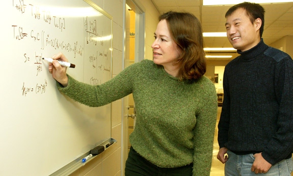 Professor Emily Carter and doctoral student Chen Huang developed a new way of predicting important properties of substances. The advance could speed the development of new materials and technologies. (Photo: Frank Wojciechowski)