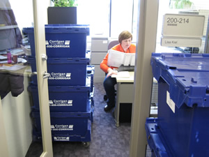 Lisa Kiel, office manager for U-M's Institutional Review Boards, is surrounded by boxes at her new office at the North Campus Research Complex. Kiel and about 30 other IRB employees will work in their new offices at NCRC for the first time today. 