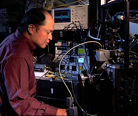 NIST physicist Sae Woo Nam works with refrigeration equipment used to cool photon detectors to nearly absolute zero. His teams efforts have created devices that can detect single photons with 99 percent efficiency. Credit: NIST