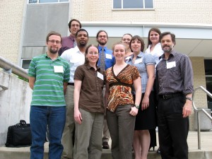 Standing in the front row, from left, is Philip Janini; Erika Gibb, assistant professor of physics and astronomy at UMSL; Lauren Stephenson; Emily Sudholt; and Bruce Wilking, chair of the Department of Physics and Astronomy at UMSL. Standing in the back row is David Peaslee; Robert Dobynes; David Coss; Rosaura Salinas; and Ellie Ordway. Not pictured is Kristen Erickson.