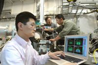 Assistant physicist Zhang Jiang (from left) examines a X-ray diffraction as physicist Jin Wang and nanoscientist Xiao-Min Lin prepare a sample at one of the Advanced Photon Sources beamlines. The Argonne scientists have examined nanoparticle crystallization in unprecedented detail using the high powered X-rays of the APS.