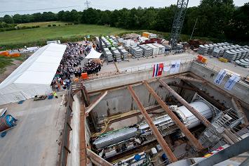 First tunnel and borer christening ceremony on the European XFEL construction site Schenefeld on 30 June 2010. In the foreground the tunnel boring machine in its start shaft. (Photo: European XFEL)