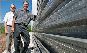 NREL's Craig Christensen and Chuck Kutscher stand next to a wall at the RSF that uses their award-winning transpired air collector technology. Credit: Dennis Schroeder