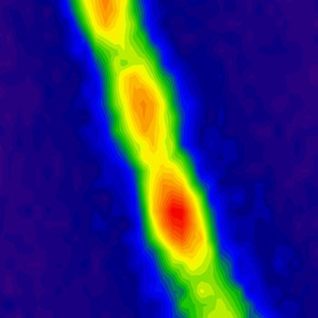 This filament containing about 30 million carbon nanotubes absorbs energy from the sun as photons and then re-emits photons of lower energy, creating the fluorescence seen here. The red regions indicate highest energy intensity, and green and blue are lower intensity. Image: Geraldine Paulus 