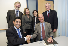 CHN Director Ahmed Busnaina (bottom, left) joins NIOSH Director John Howard and other collaborators to sign the agreement. Photo by Mary Knox Merrill.