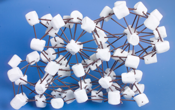 Marshmallows connected with coffee stirrers represent hairy spheres in a crystal structure.