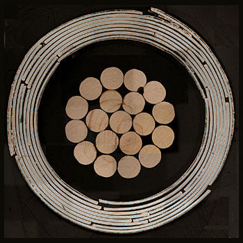 Cross-section of a high-temperature superconducting cable design invented at NIST. In the center are copper wires bundled with nylon and plastic insulation. The outer rings are a series of superconducting tapes wrapped in spirals around the copper. The cable is 7.5 millimeters in outer diameter.
Credit: van der Laan/NIST
