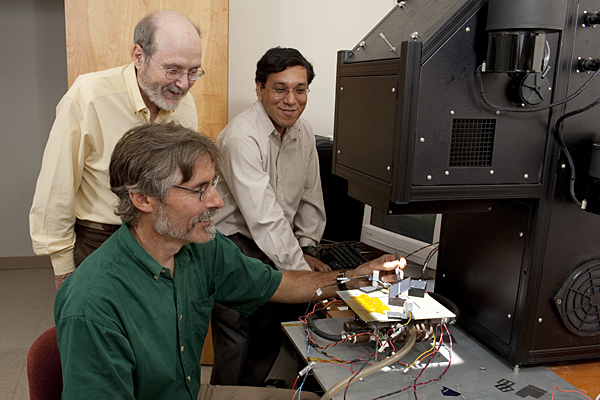 Steve Hegedus (seated), Robert Birkmire and Ujjwal Das at work at the University of Delaware's Institute of Energy Conversion. Hegedus will lead a $3.3 million project, along with Birkmire and Das, to lower the cost of crystalline silicon solar cells.
