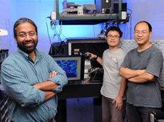 Iowa State University and Ames Laboratory researchers, left to right, Sanjeevi Sivasankar, Chi-Fu Yen and Hui Li have invented microscope technology to study single biological molecules. Larger photo. Photo by Bob Elbert.