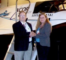 Dale Amon, NSS Archivist, and Kathy Harper, NMMSH Marketing & Public Relations in front of the Lynx I Spaceplane mock-up at the 2012 International Symposium for Personal and Commercial Spaceflight conference in Las Cruces