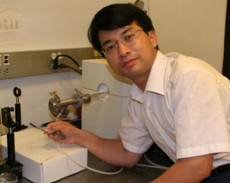 Chongwu Zhou holds up a piece of plastic substrate used to build nanoscale transistors and circuits.