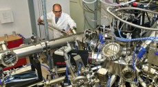 Brookhaven Lab physicist Ivan Bozovic with the molecular beam epitaxy system he uses to engineer atomically precise superconducting materials.