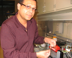 Dr. Alamgir Karim holds a strip of the polymer thin film that can now be produced at an industrial level for use in a wide range of applications.
