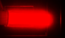Bright light emission from silicon quantum dots in a cuvette. The image is from a camera that captures the near-infrared light that the quantum dots emit. The light emission shown is a psuedo color, as near-infrared light does not fall in the visible spectrum. Credit: Folarin Erogbogbo