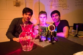 MIT students (left to right) Ayush Bhandari, Refael Whyte and Achuta Kadambi pose next to their "nano-camera" that can capture translucent objects, such as a glass vase, in 3-D.
Photo: Bryce Vickmark