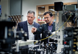 Physics Professor Ali Koymen, left, and Samarendra Mohanty, an assistant professor of physics, discuss their research.