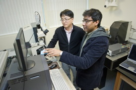 In this file photo, Swastik Kar (right), and Yung Joon Jung use a Raman Spectrometer to characterize the assembly of a carbon nanotube. Photo by Mary Knox Merrill