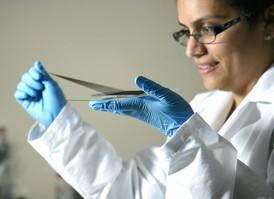 Dr. Raquel Ovalle-Robles MS06 PhD08, chief research and intellectual properties strategist at Lintec of Americas Nano-Science & Technology Center, draws a sheet of material from a carbon nanotube forest. The center will begin the manufacture and commercialization of carbon nanotube structures, which are produced by a process developed by UT Dallas scientists.