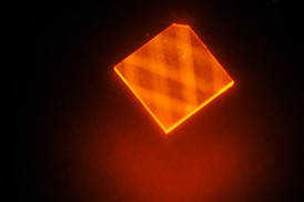 In this image, laser light enters a synthetic diamond from a facet at its corner and bounces around inside the diamond until its energy is exhausted. This excites "nitrogen vacancies" that can be used to measure magnetic fields.

image: H. Clevenson/MIT Lincoln Laboratory