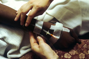 This image shows two hands manipulating an IV for chemotherapy administration to a patient.
CREDIT: National Cancer Institute - Linda Bartlett