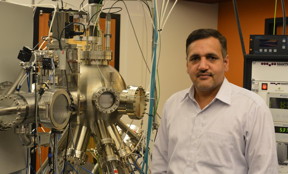 Vidyadhar Singh is standing next to the advanced nanoparticle deposition system at OIST.
CREDIT: OIST