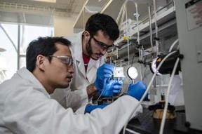 (From left to right): Chengxiang Xiang and Erik Verlage assemble a monolithically integrated III-V device, protected by a TiO2 stabilization layer, which performs unassisted solar water splitting with collection of hydrogen fuel and oxygen.
Credit: Lance Hayashida/Caltech