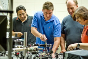 University of Vermont scientists have invented a new way to create what they are calling an electron superhighway in an organic semiconductor that promises to allow electrons to flow faster and farther -- aiding the hunt for flexible electronics, organic solar cells, and other low-cost alternatives to silicon. To explore these organic materials, UVM graduate students (from left) Naveen Rawat and Lane Manning, and professors Randy Headrick and Madalina Furis, deployed this table-top scanning laser microscope. Their latest finding is reported in the journal Nature Communications -- and may, someday not too far off, let you roll up your computer like a piece of paper.
CREDIT: Joshua Brown, UVM