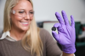 Vanderbilt graduate student Anna Douglas holding one of the batteries that she has modified by adding millions of quantum dots made from iron pyrite, fool's gold.
CREDIT: John Russell, Vanderbilt University