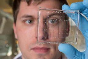 James Dahlman, an assistant professor in the Wallace H. Coulter Department of Biomedical Engineering at Georgia Tech and Emory University, holds a microfluidic chip used to fabricate nanoparticles that could be used to deliver therapeutic genes.
CREDIT
Credit: Rob Felt, Georgia Tech
