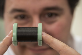Rice University chemist Matteo Pasquali shows a spool of fiber made of carbon nanotubes. Rice has joined the Department of Energy's Next Generation Machines: Enabling Technologies initiative and will work to increase the conductivity of the fiber for use in electric motors. (Credit: Jeff Fitlow/Rice University)