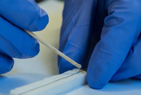 Rice University graduate student Amram Bengio prepares a sample nanotube fiber antenna for evaluation. The fibers had to be isolated in Styrofoam mounts to assure accurate comparisons with each other and with copper. The Rice fibers made only of carbon nanotubes may be practical antennas for aerospace applications and wearable electronics. (Credit: Jeff Fitlow/Rice University)