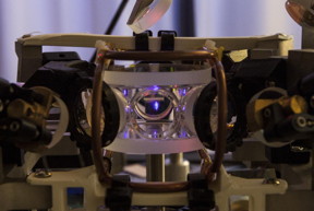 This is a cooled and trapped cloud of cold atoms used to realize the quantum memory protocol. The atoms reside in the center of the vacuum chamber, around which the magnetic coils necessary to trap the atoms are visible. The blue color is caused by two near-infrared lasers illuminating the atoms and driving a two-photon transition, which results in spontaneous emission of visible blue light. (Source: FUW, Mateusz Mazelanik)
CREDIT
Source: FUW, Mateusz Mazelanik