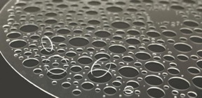 Fused silica wafer with thickness of 350 um with high-quality glass vias of diameters between 0.25 mm and 6 mm fabricated by selective laser etching. From 10.1117/1.OE.60.2.025105

CREDIT
Daniel Flamm et al.